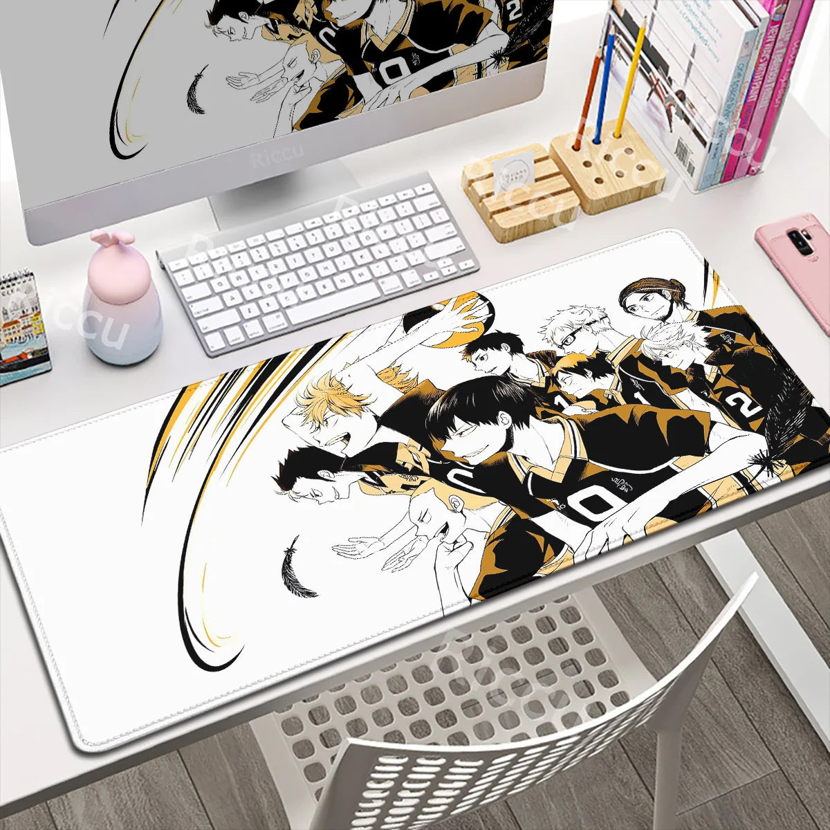 Anime-themed mouse pad on a desk with a computer setup
