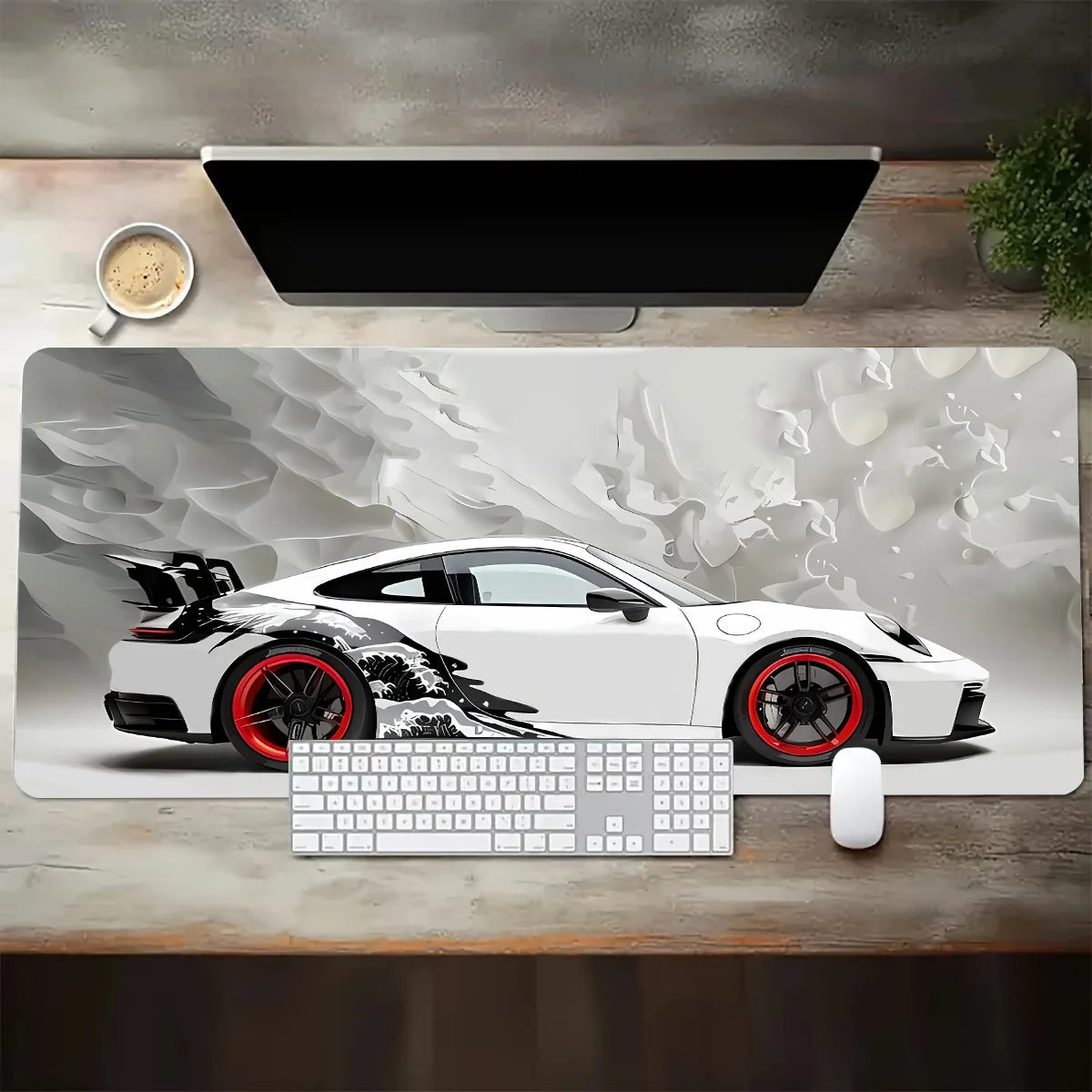 Desk setup with a large mouse pad featuring a sports car design, keyboard, and mouse.