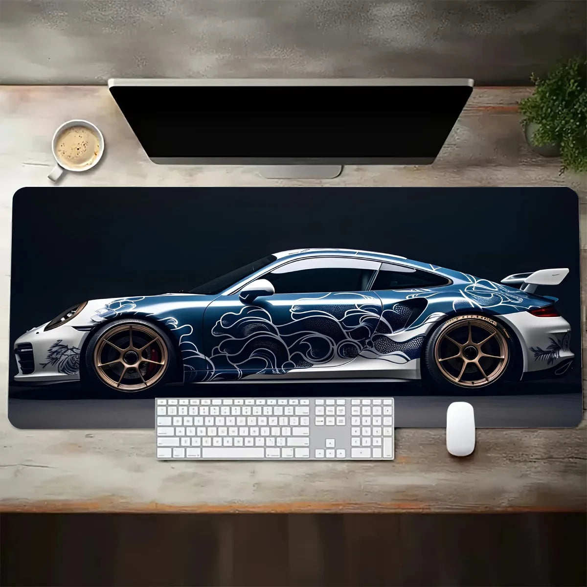 Desk setup with a car-themed mouse pad, keyboard, and mouse on a wooden surface.