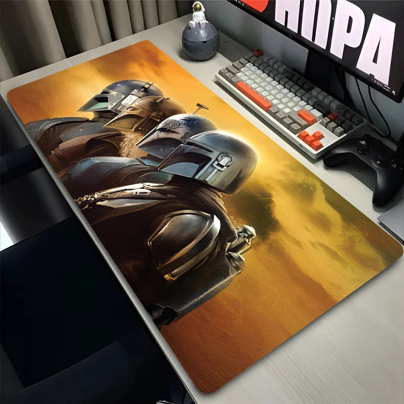 Desk setup with a large mouse pad featuring a helmet design, keyboard, and monitor.