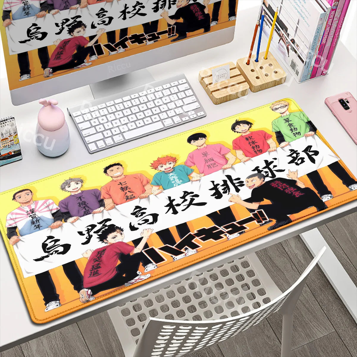 Desk setup with a large mouse pad featuring cartoon characters and text.
