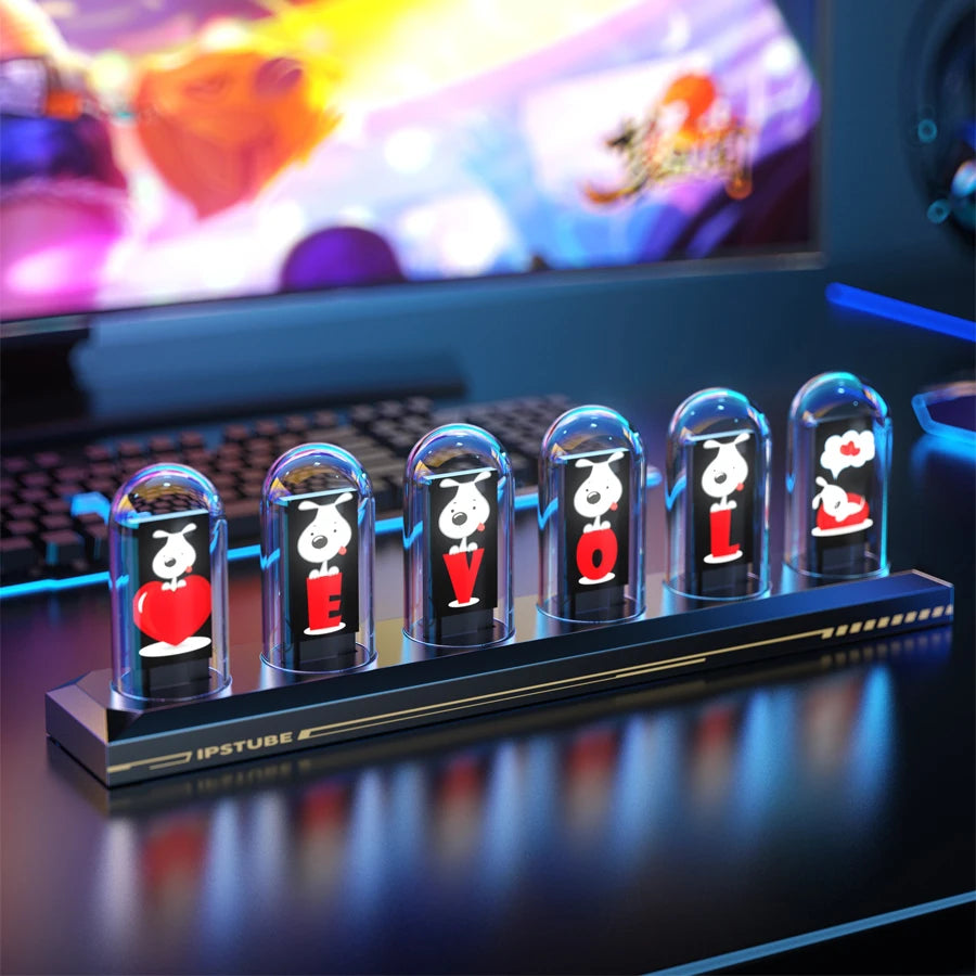 LED display with character designs on a desk in front of a computer screen
