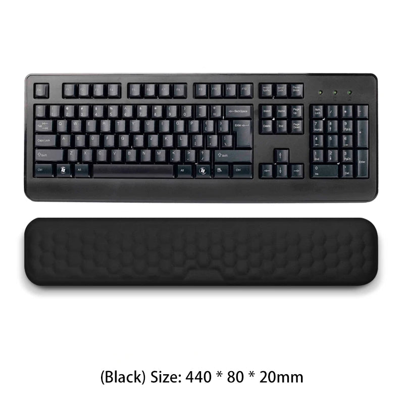 Black keyboard with wrist rest on a white background
