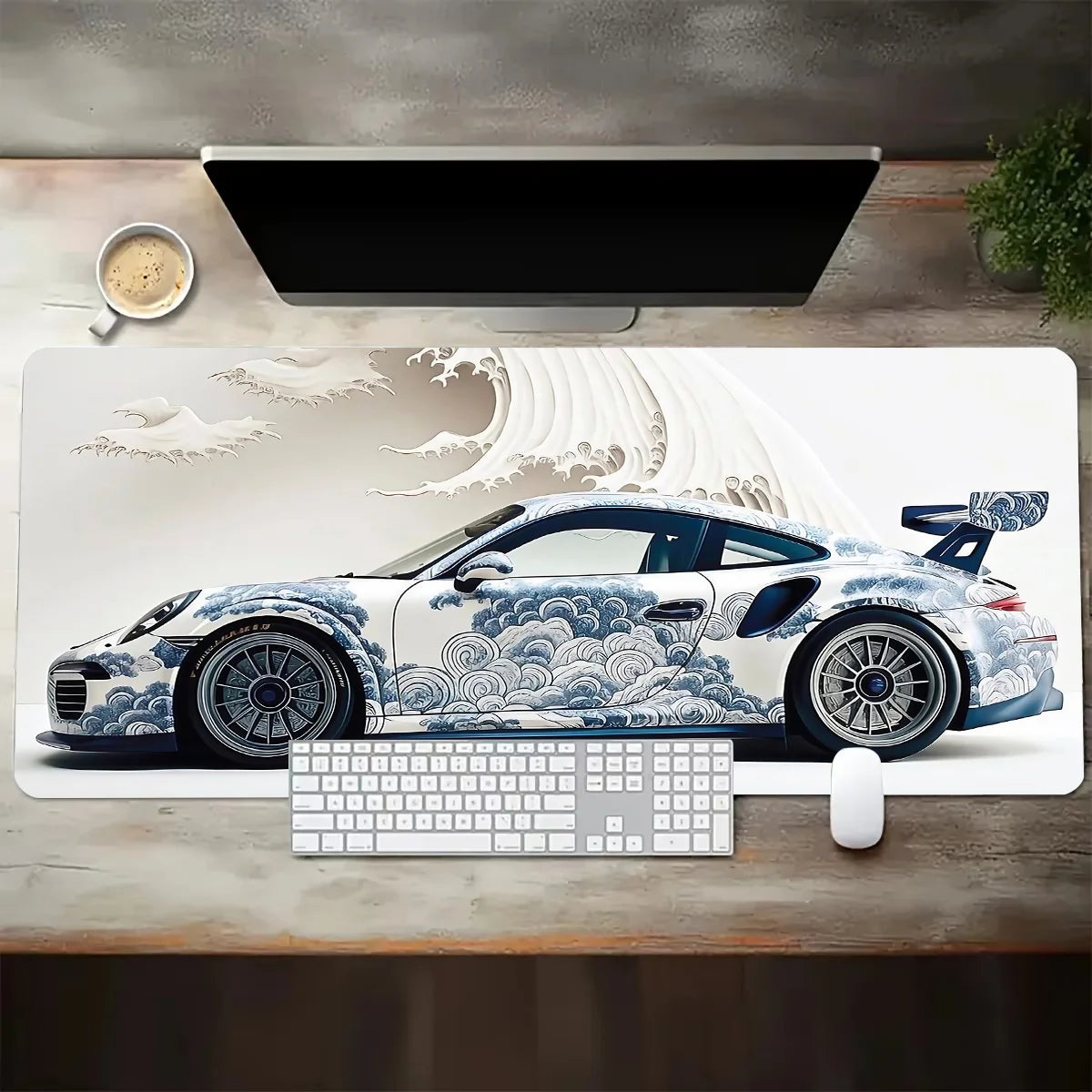 Desk setup with a large mouse pad featuring a car design, keyboard, and mouse on a wooden desk.