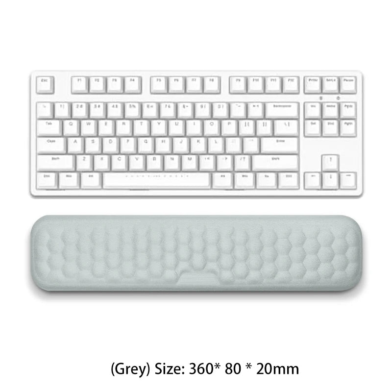 White keyboard with a gray wrist pad on a white background