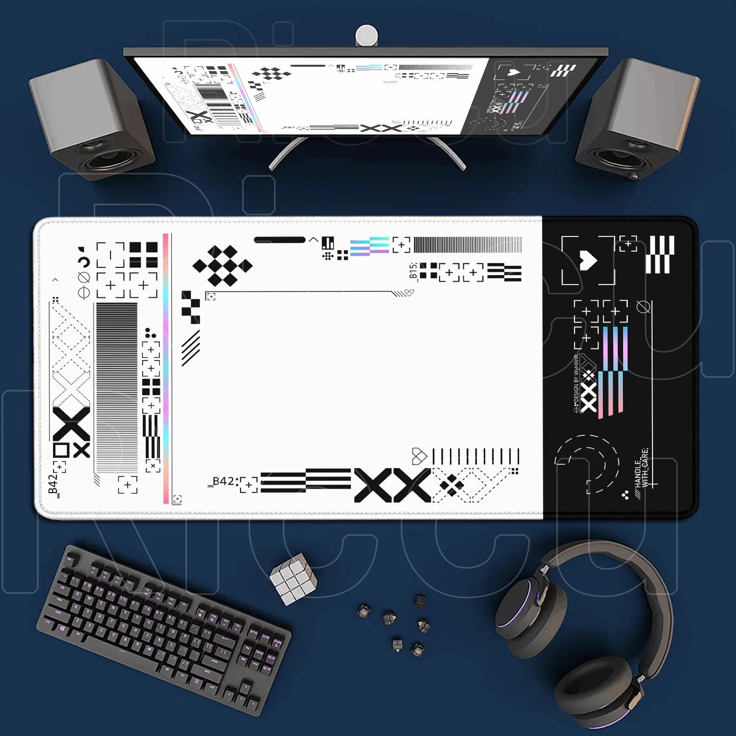Computer setup with monitor, keyboard, mouse, headphones, and desk mat on a blue background