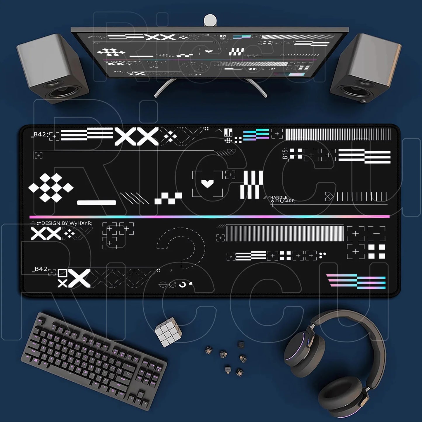 Gaming setup with monitor, keyboard, mouse, and headphones on a blue surface
