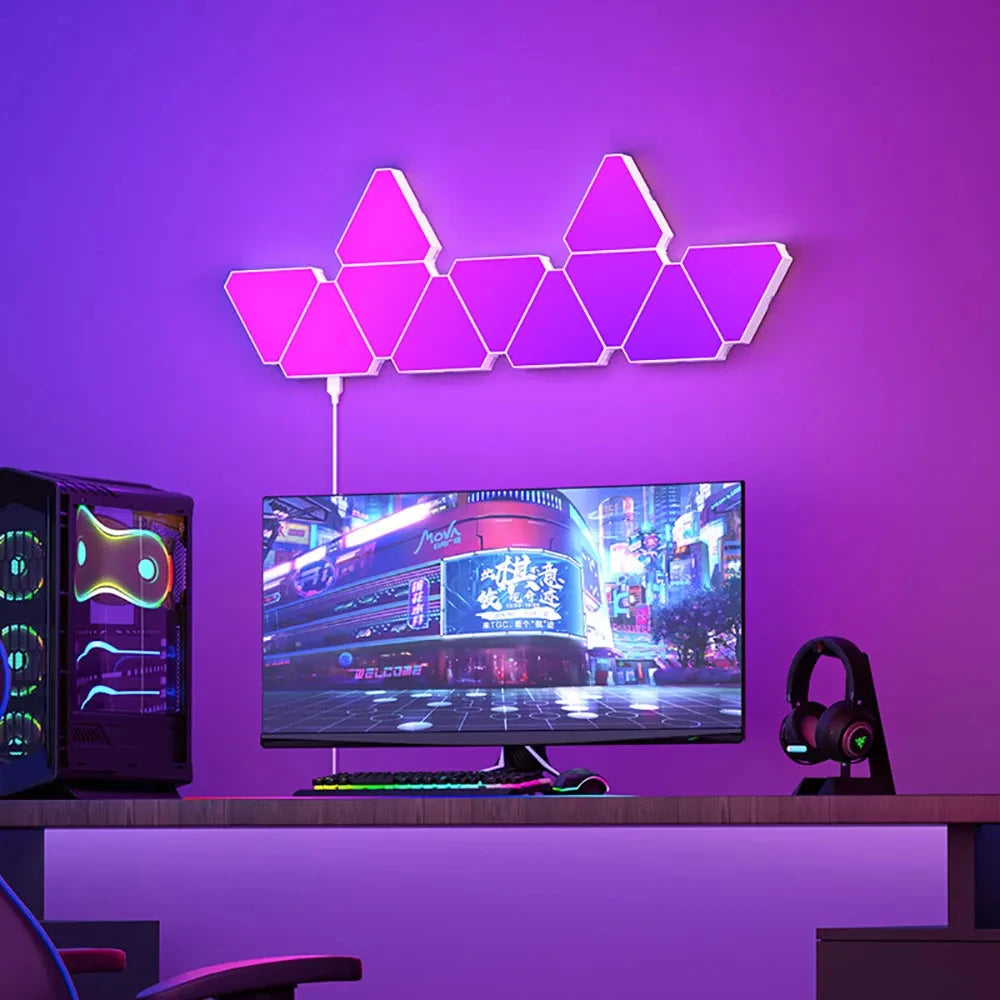 Neon triangular lights on a purple wall above a computer setup with a monitor, keyboard, and gaming chair.