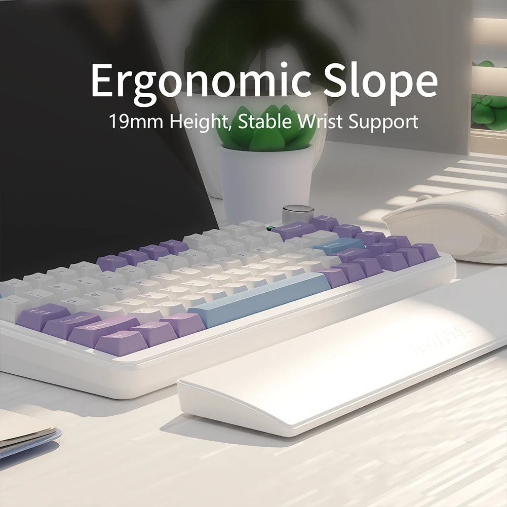 Ergonomic keyboard with text highlighting slope and wrist support on a desk.