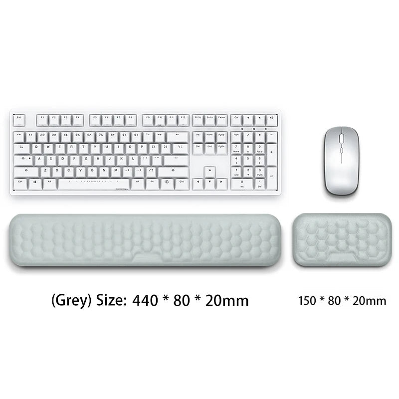 Gray keyboard, mouse, and wrist rest on a white background