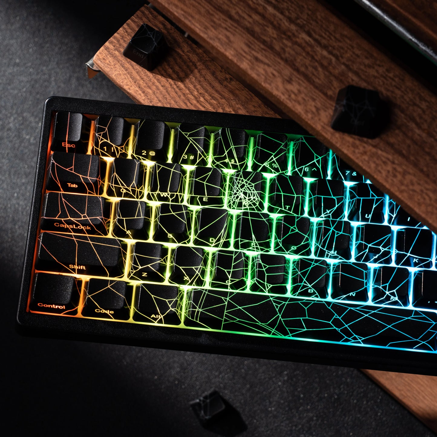 Glowing keyboard with spider web design on a dark surface