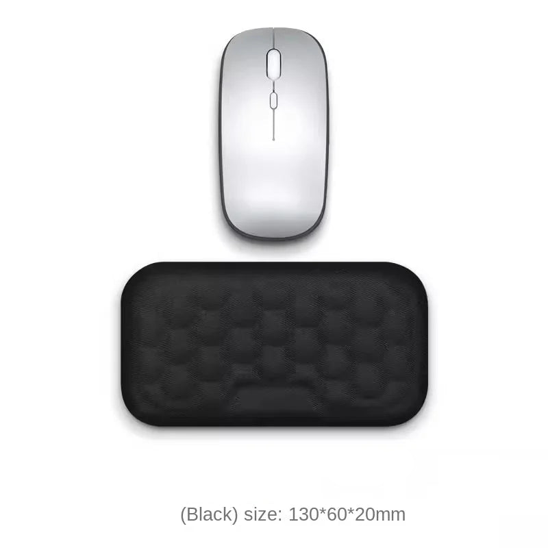 Silver computer mouse and black mouse pad on a white background