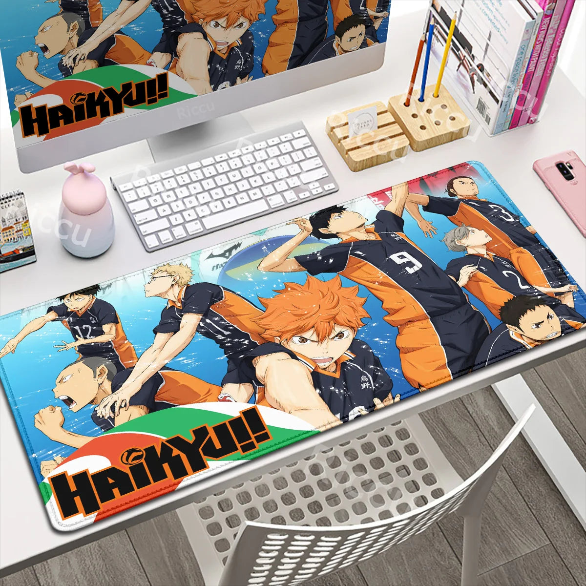 Desk setup with a Haikyuu!! themed mouse pad, keyboard, and stationery items.