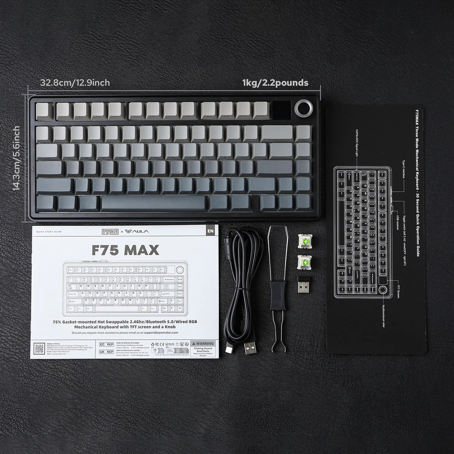 Mechanical keyboard with packaging, cables, and tools on a black surface