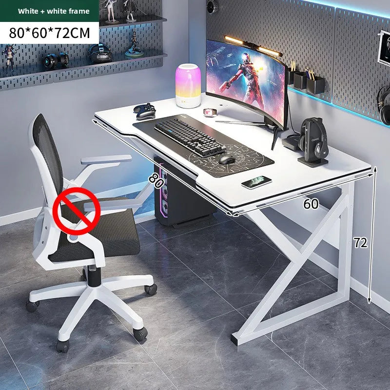 Gaming desk setup with chair, monitor, and accessories in a room.