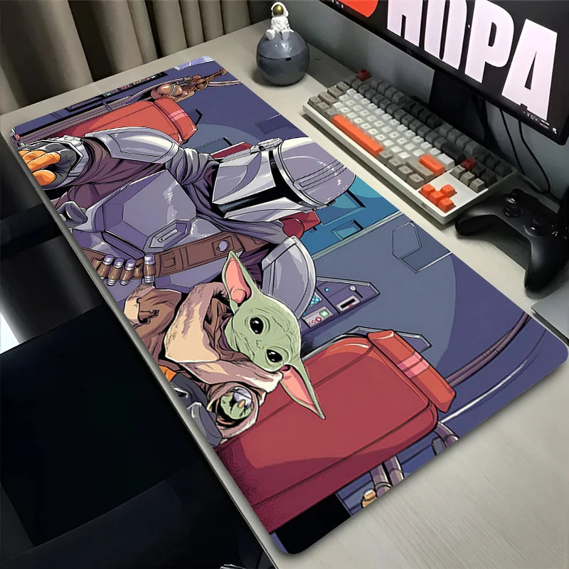 Desk setup with a large mouse pad featuring a character design, keyboard, and monitor.