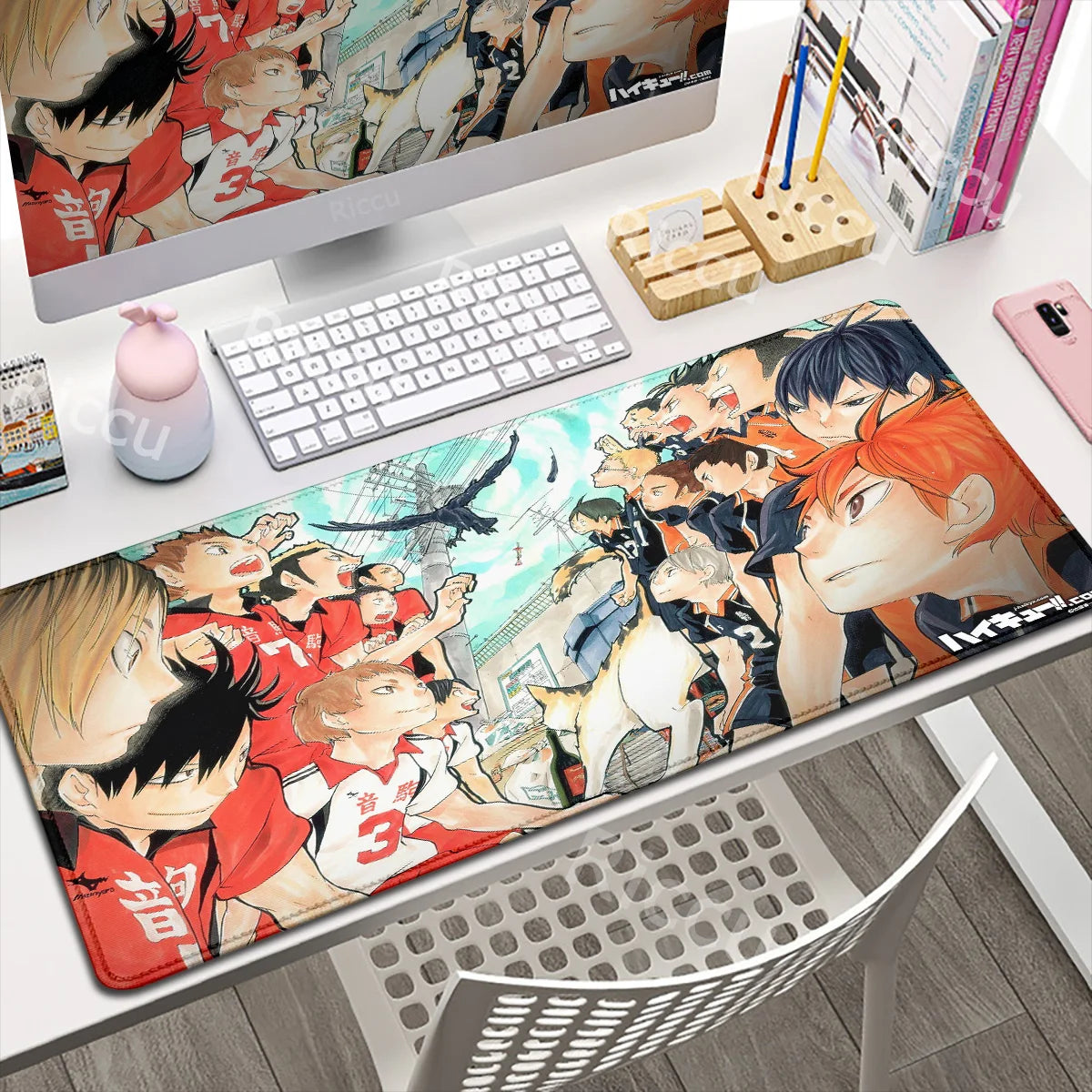 Anime-themed desk setup with a large mouse pad featuring character designs.