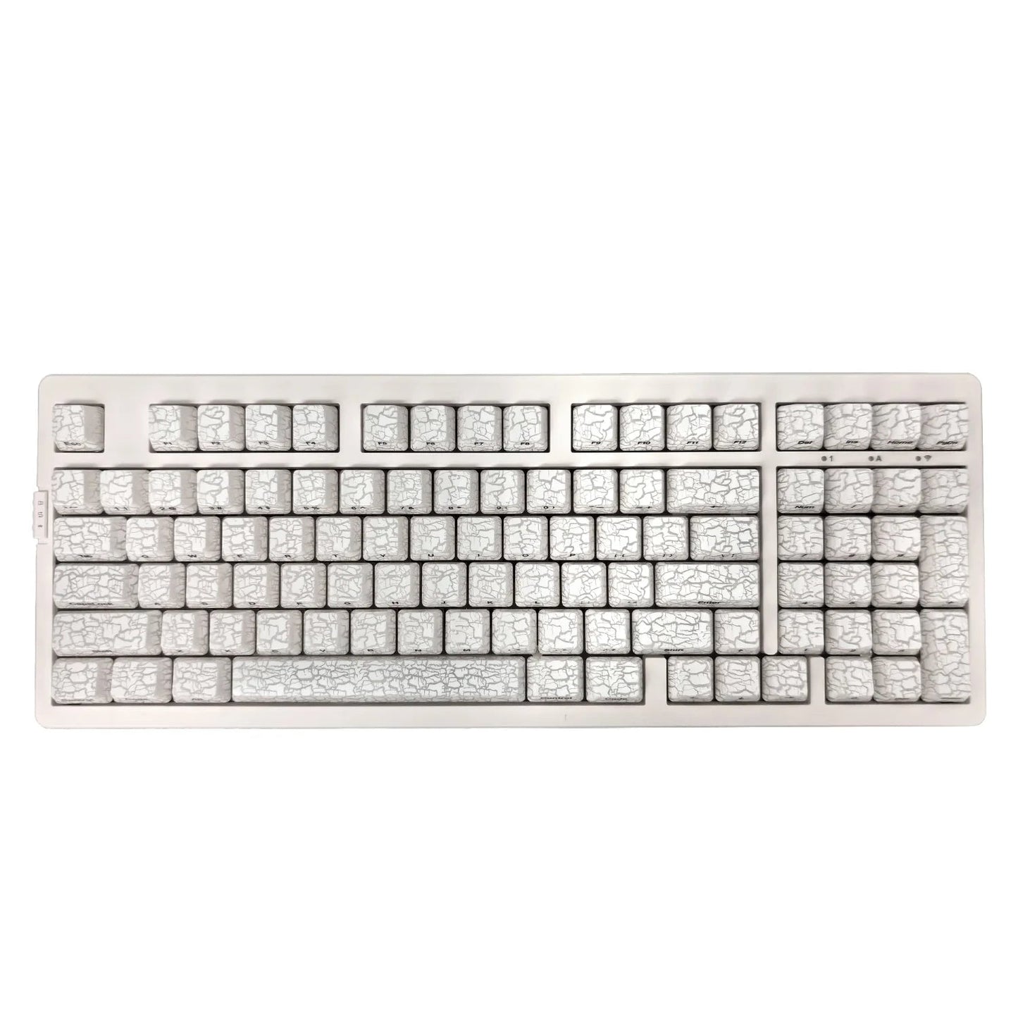 Mechanical keyboard with ice crack pattern on a white background