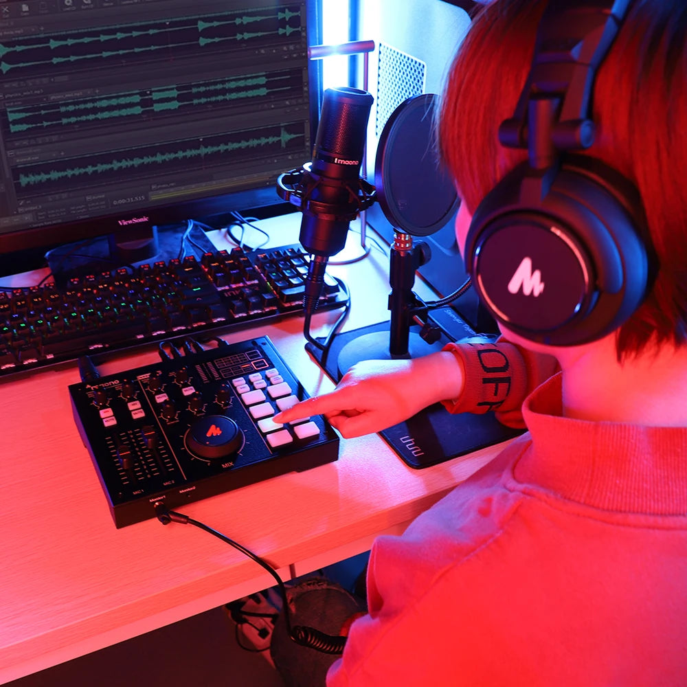 Person in a home studio setting with music production equipment.