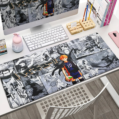 Desk setup with a large mouse pad featuring anime-style artwork, including a character in a sports uniform.
