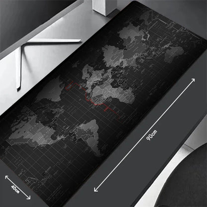 Large world map desk mat on a desk with dimensions indicated