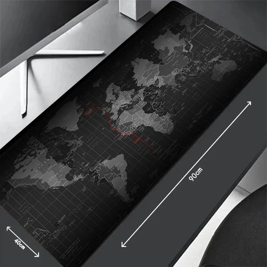 Large world map desk mat on a desk with dimensions indicated