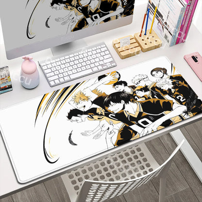 Anime-themed mouse pad on a desk with a computer setup