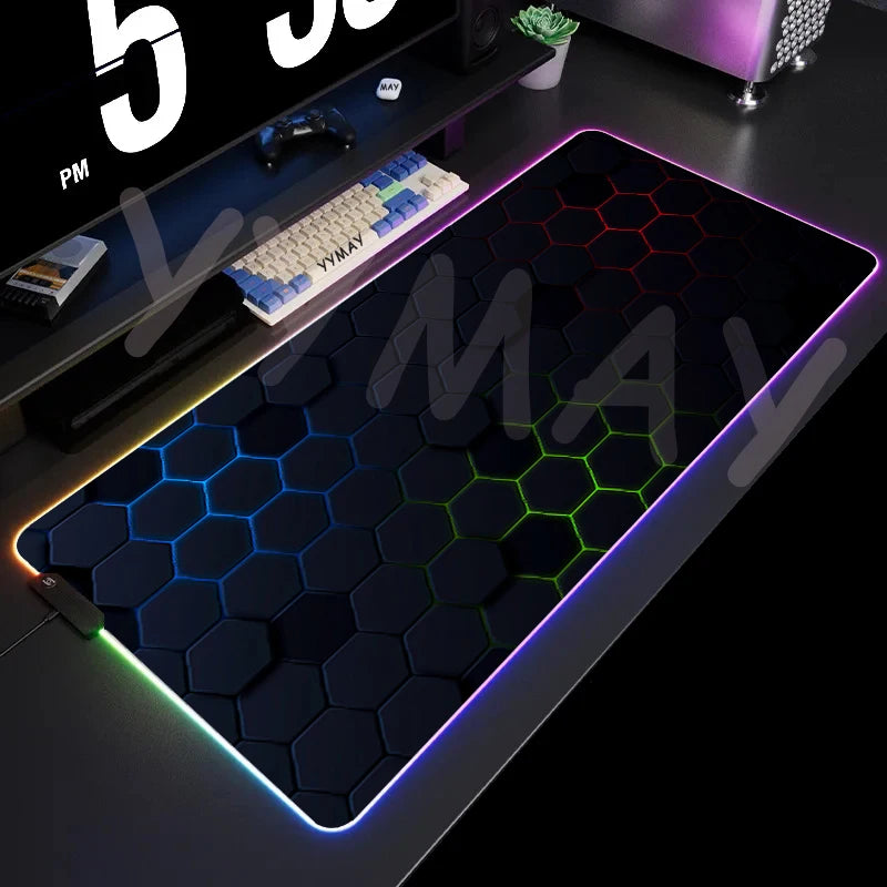 Gaming desk setup with a large RGB mouse pad, keyboard, and computer equipment.