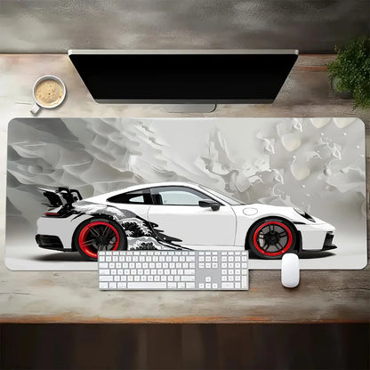 Desk setup with a large mouse pad featuring a sports car design, keyboard, and mouse.