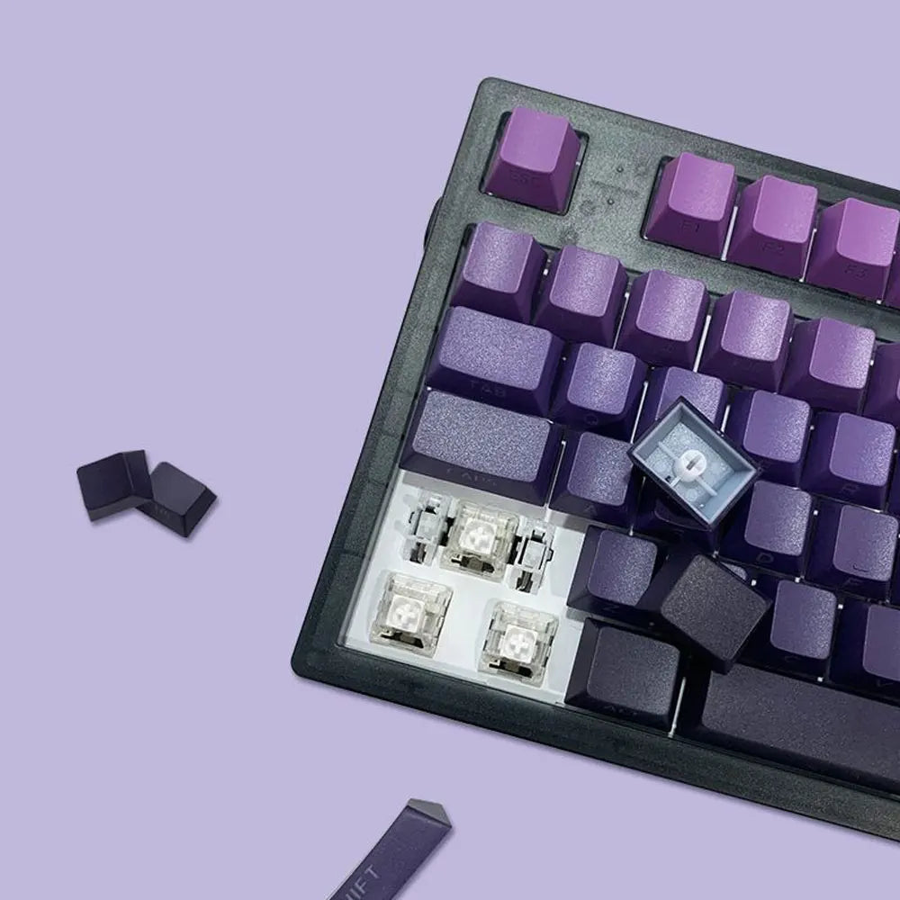Close-up of a mechanical keyboard with purple and black keys on a light purple background