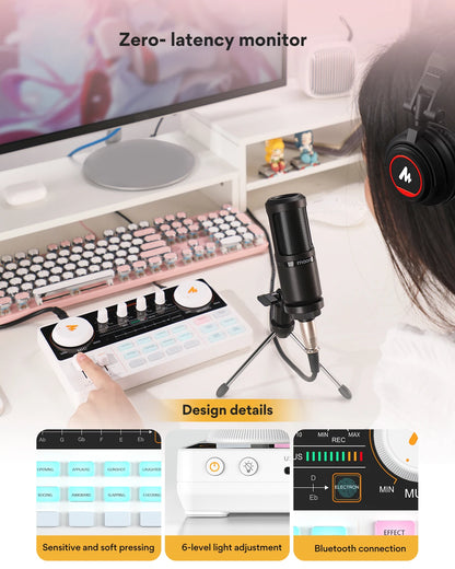 Microphone setup with monitor, keyboard, and controller on a desk.
