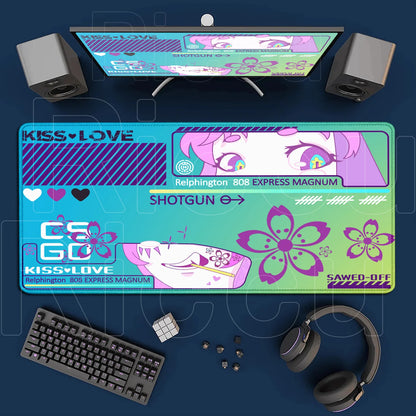 Gaming setup with a colorful mouse pad, keyboard, headphones, and monitor on a blue surface.