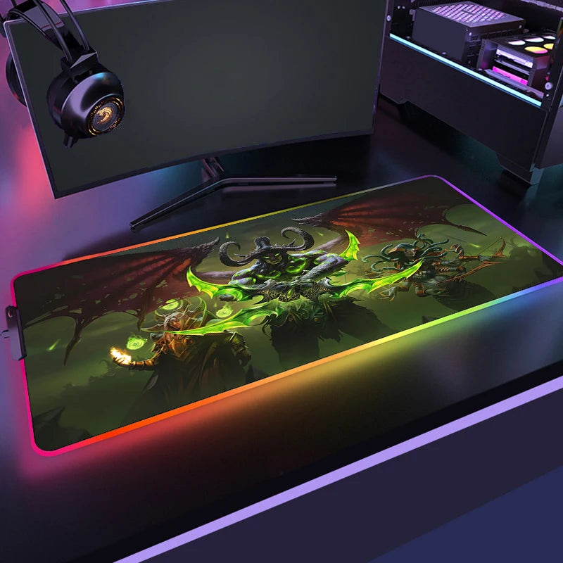 Gaming setup with a large mouse pad featuring a dragon design, monitor, and headphones on a desk.