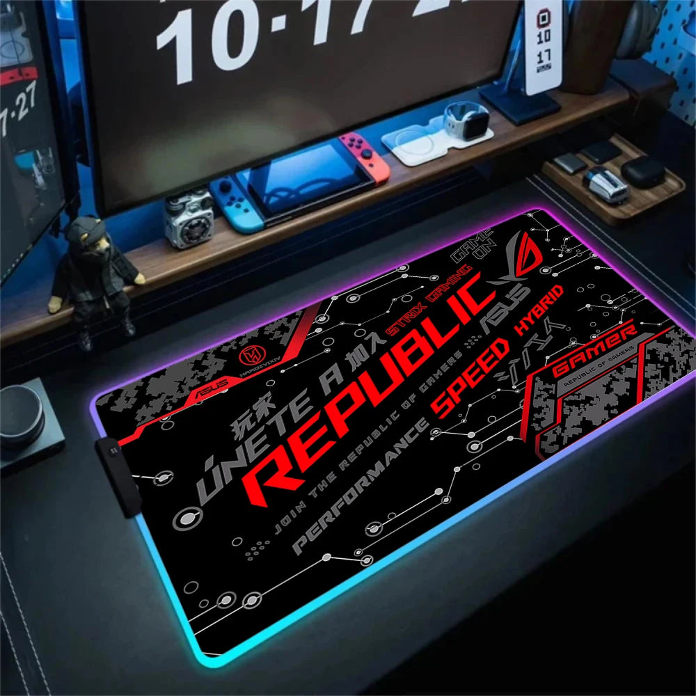 Gaming desk setup with a Republic 4 mouse pad, computer monitors, and gaming accessories.