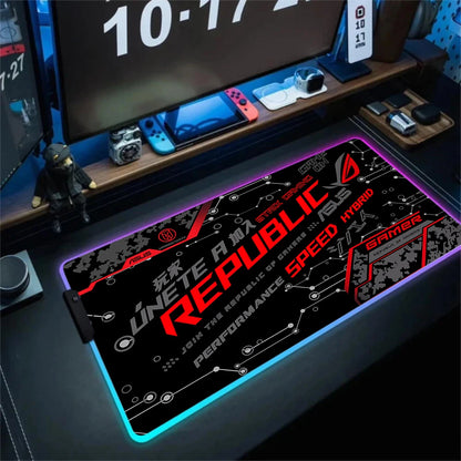 Gaming desk setup with a Republic 4 mouse pad, computer monitors, and gaming accessories.