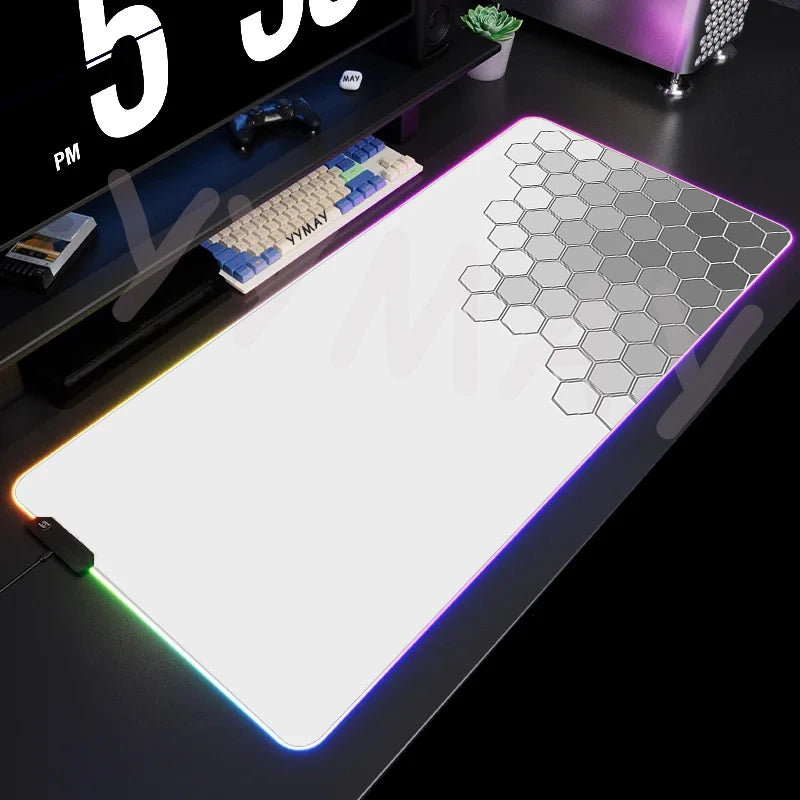 Gaming desk setup with a large mouse pad featuring a geometric pattern.