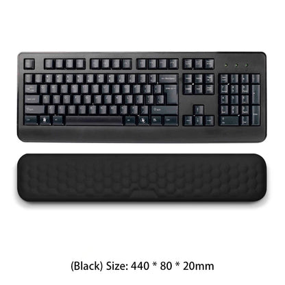 Black keyboard with wrist rest on a white background