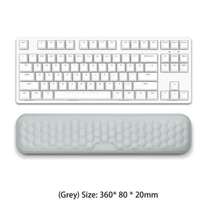 White keyboard with a gray wrist pad on a white background