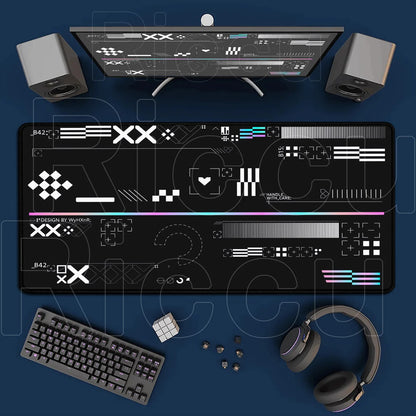 Gaming setup with monitor, keyboard, mouse, and headphones on a blue surface