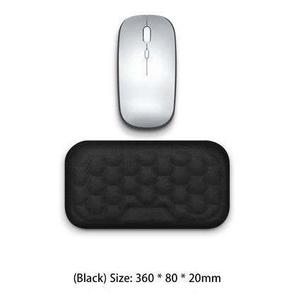 Silver computer mouse and black mouse pad on a white background
