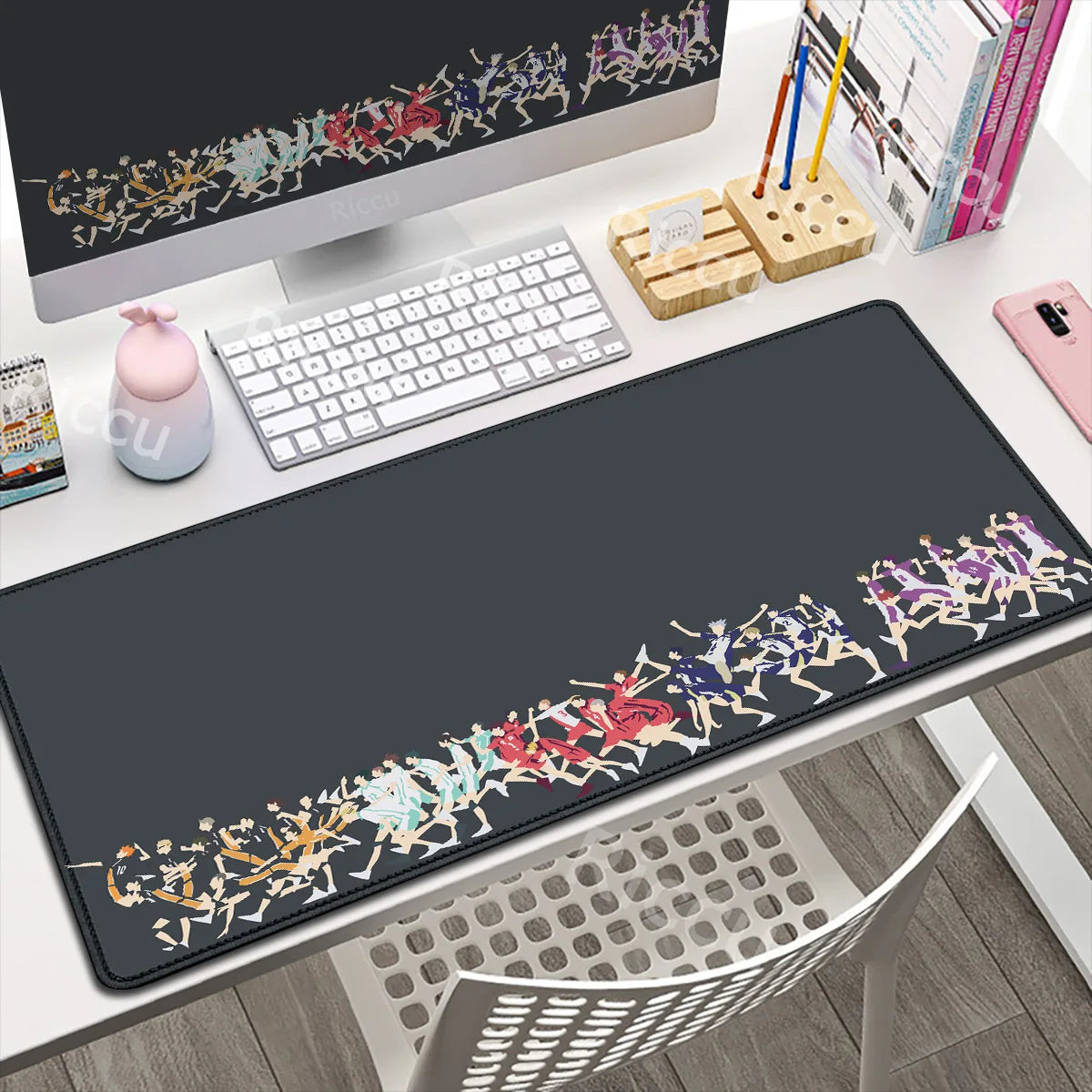 Desk setup with a large decorative mouse pad featuring colorful designs.