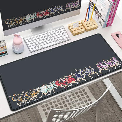 Desk setup with a large decorative mouse pad featuring colorful designs.