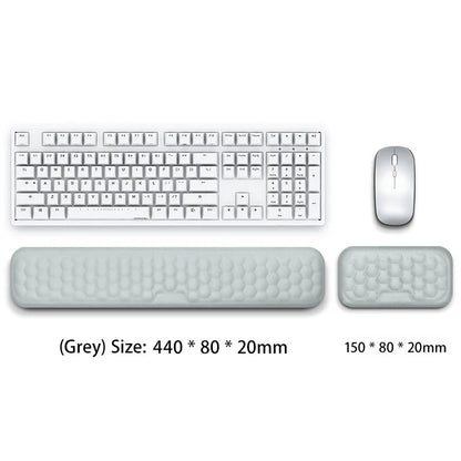 Gray keyboard, mouse, and wrist rest on a white background