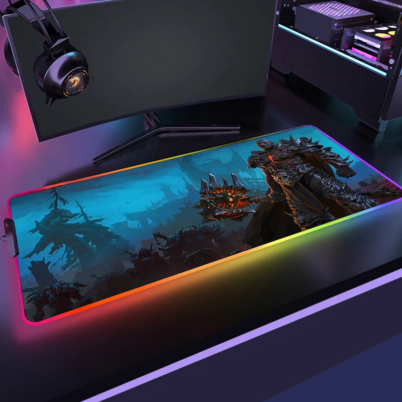 Gaming desk setup with a large mouse pad featuring a fantasy design and RGB lighting.