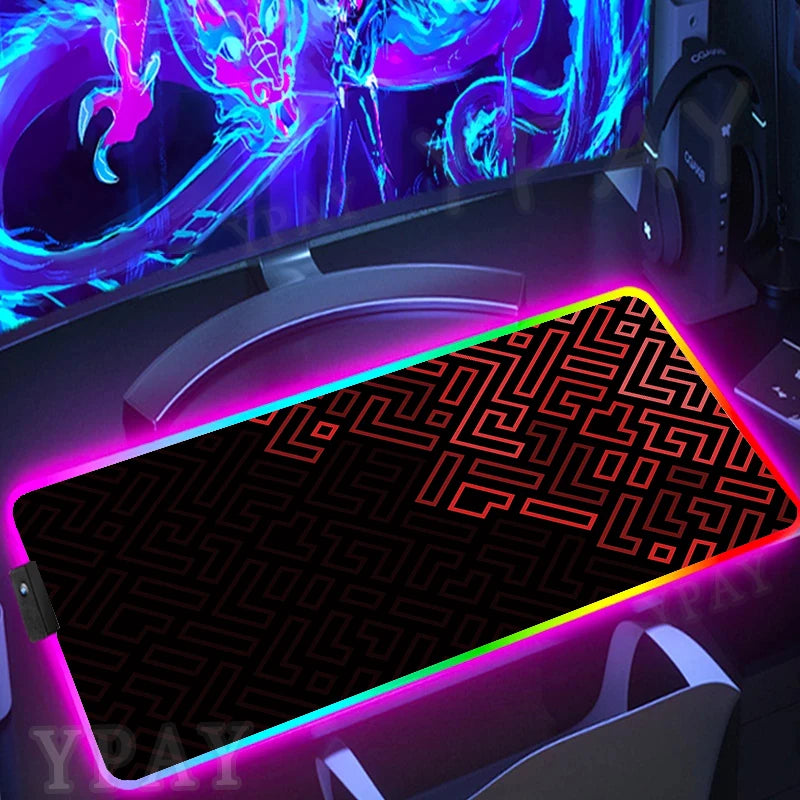 Gaming setup with a large mouse pad featuring a maze design and colorful lighting.