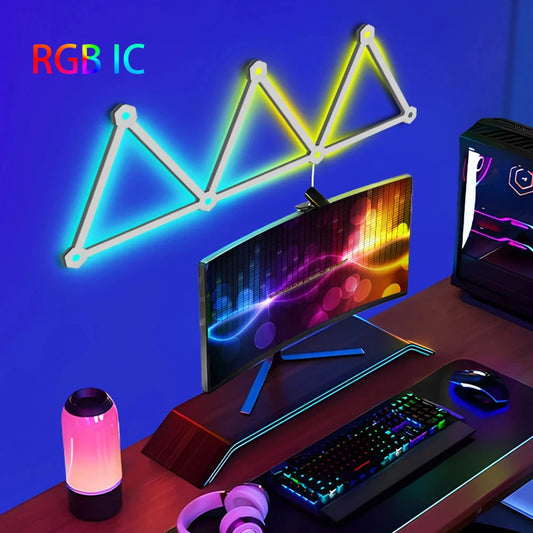 Gaming desk setup with RGB lighting effects on a blue wall.