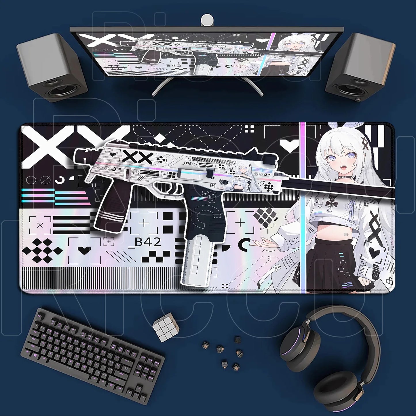 Gaming setup with a large mouse pad featuring graphics and text, keyboard, headphones, and computer monitor on a blue surface.