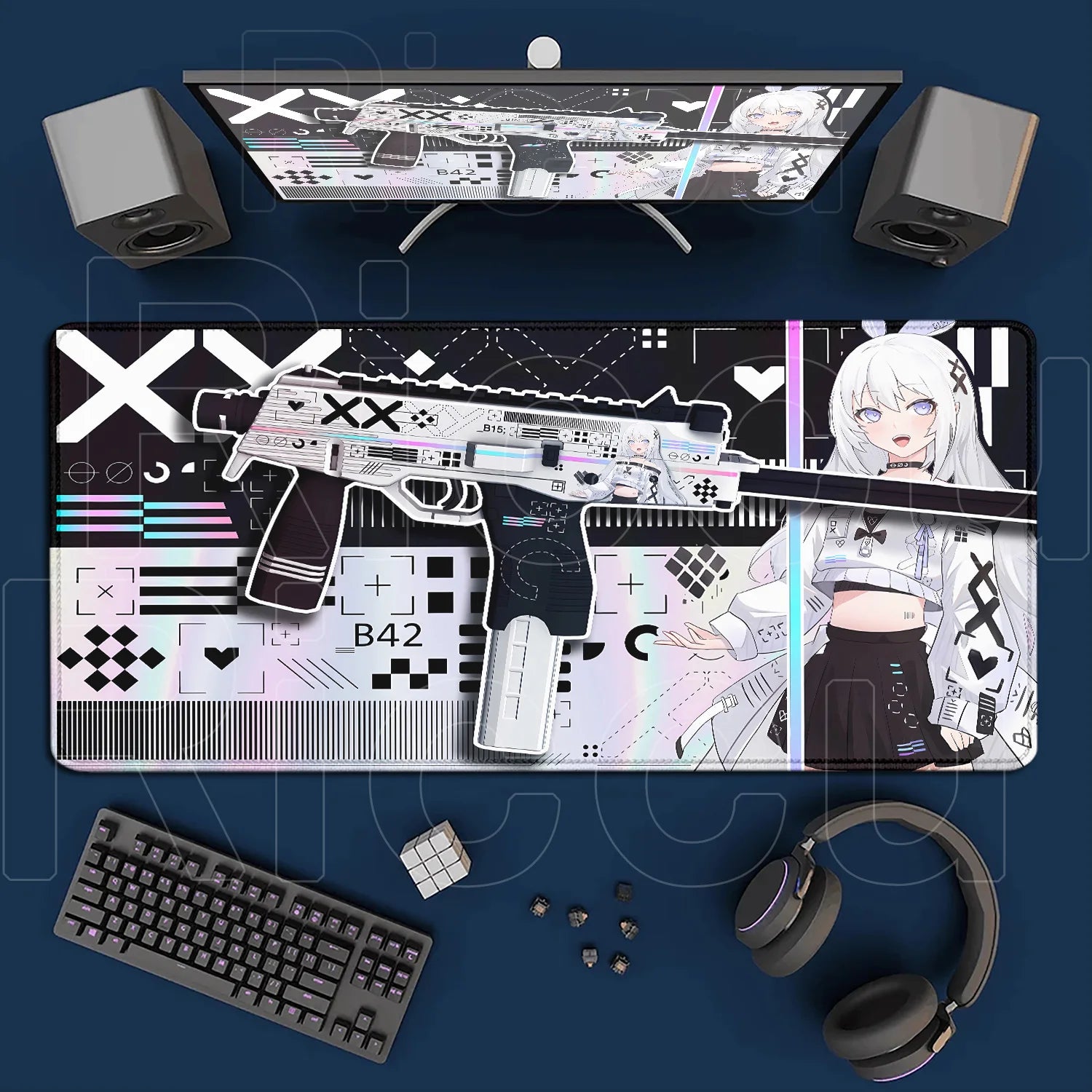 Gaming setup with a large mouse pad featuring graphics and text, keyboard, headphones, and computer monitor on a blue surface.
