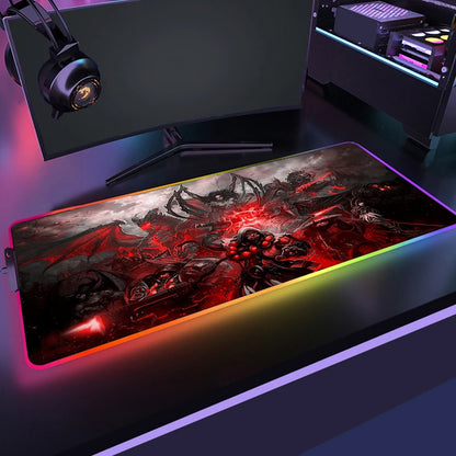 Gaming setup with a large mouse pad featuring a dragon design, monitor, and RGB lighting.
