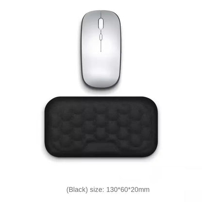 Silver computer mouse and black mouse pad on a white background